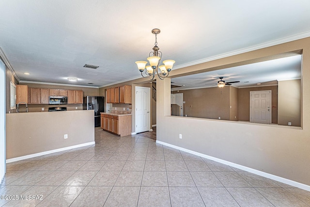 1173 W Calle Vista De Suenos, Sahuarita, AZ 85629 - kitchen featuring stainless steel microwave, black fridge, open floor plan, a chandelier, and brown cabinetry