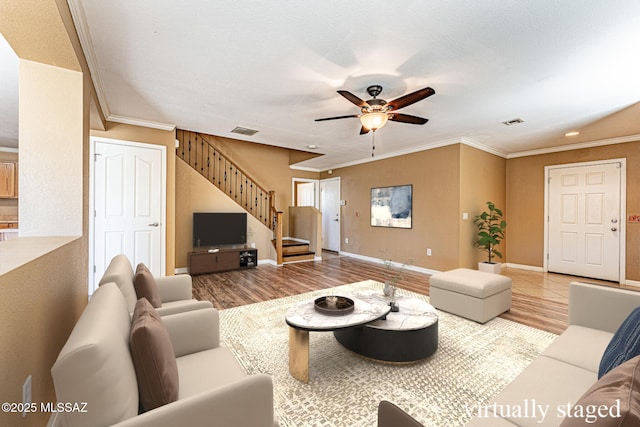 1173 W Calle Vista De Suenos, Sahuarita, AZ 85629 - living room featuring stairway, a ceiling fan, crown molding, wood finished floors, and baseboards
