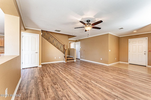 1173 W Calle Vista De Suenos, Sahuarita, AZ 85629 - unfurnished living room with ceiling fan, crown molding, light wood finished floors, stairs, and baseboards