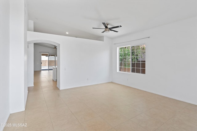 12122 N Sterling Ave, Oro Valley, AZ 85755 - unfurnished room featuring a ceiling fan, arched walkways, plenty of natural light, and baseboards