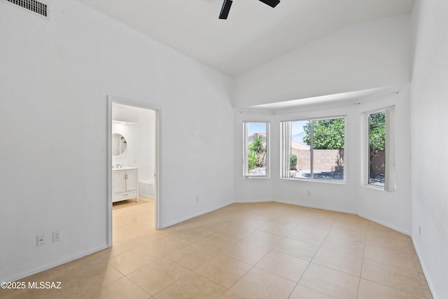 12122 N Sterling Ave, Oro Valley, AZ 85755 - spare room with high vaulted ceiling, a ceiling fan, light tile patterned floors, and baseboards