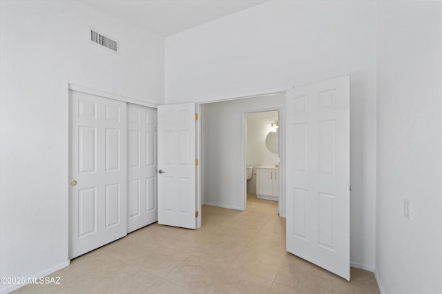 12122 N Sterling Ave, Oro Valley, AZ 85755 - unfurnished bedroom with baseboards, light tile patterned floors, and a closet