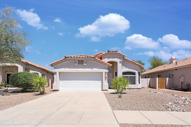 12122 N Sterling Ave, Oro Valley, AZ 85755 - mediterranean / spanish-style home featuring an attached garage, stucco siding, driveway, and a tile roof