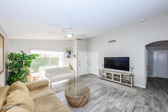 2943 N Gold Creek Pl, Tucson, AZ 85745 - living area featuring a ceiling fan, wood finished floors, arched walkways, and baseboards
