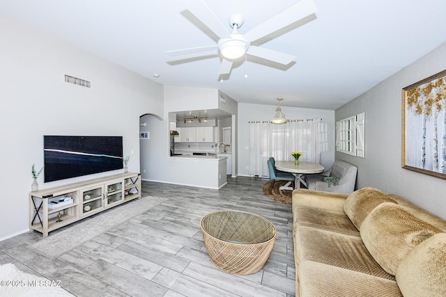 2943 N Gold Creek Pl, Tucson, AZ 85745 - living area featuring vaulted ceiling, a ceiling fan, and baseboards