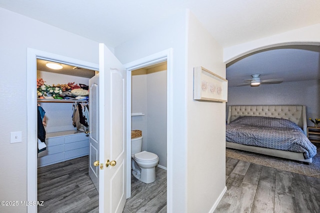 2943 N Gold Creek Pl, Tucson, AZ 85745 - ensuite bathroom featuring wood finished floors, toilet, a ceiling fan, and a spacious closet