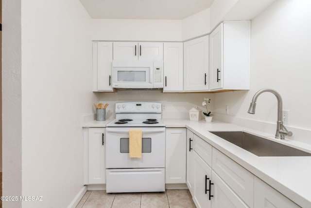 1600 N Wilmot Rd Unit 155, Tucson, AZ 85712 - kitchen with white appliances, a sink, light tile patterned floors, white cabinets, and light countertops