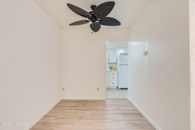 1600 N Wilmot Rd Unit 155, Tucson, AZ 85712 - empty room with ceiling fan, light wood-style flooring, and baseboards