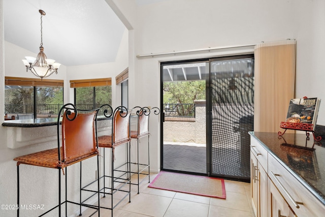 7133 E Grey Fox Ln, Tucson, AZ 85750 - doorway with light tile patterned floors, a chandelier, healthy amount of natural light, and lofted ceiling