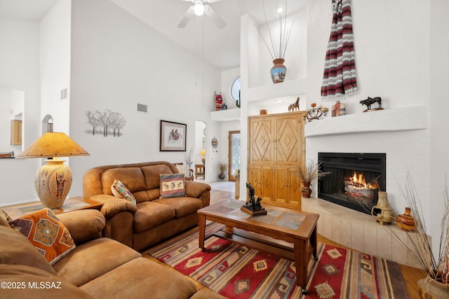 7133 E Grey Fox Ln, Tucson, AZ 85750 - living room featuring high vaulted ceiling, a ceiling fan, and a tiled fireplace
