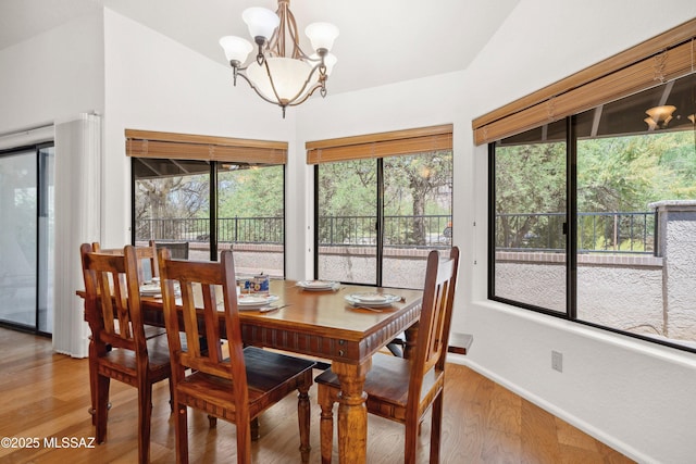 7133 E Grey Fox Ln, Tucson, AZ 85750 - dining space with light wood-type flooring, a chandelier, healthy amount of natural light, and baseboards