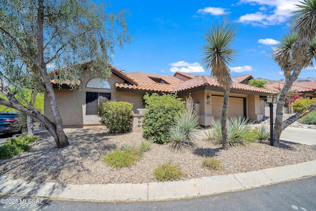 7133 E Grey Fox Ln, Tucson, AZ 85750 - view of front facade with stucco siding, a garage, and a tiled roof