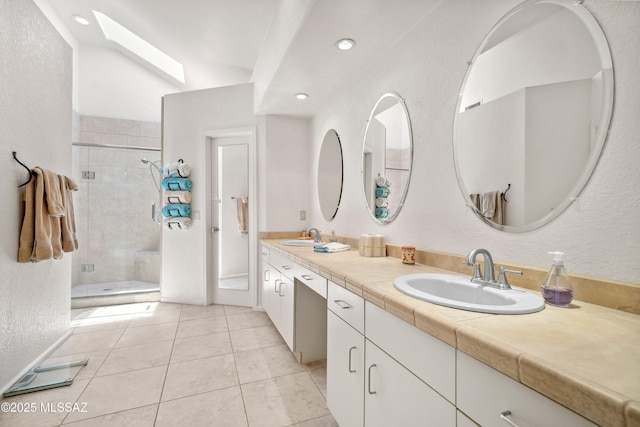 7133 E Grey Fox Ln, Tucson, AZ 85750 - full bath featuring a skylight, a shower stall, tile patterned floors, double vanity, and recessed lighting