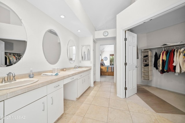 7133 E Grey Fox Ln, Tucson, AZ 85750 - bathroom with tile patterned flooring, double vanity, ensuite bath, recessed lighting, and a spacious closet