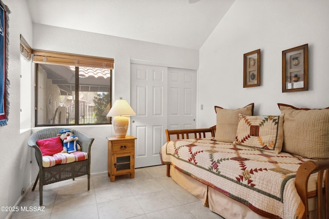7133 E Grey Fox Ln, Tucson, AZ 85750 - bedroom with vaulted ceiling, a closet, light tile patterned floors, and baseboards
