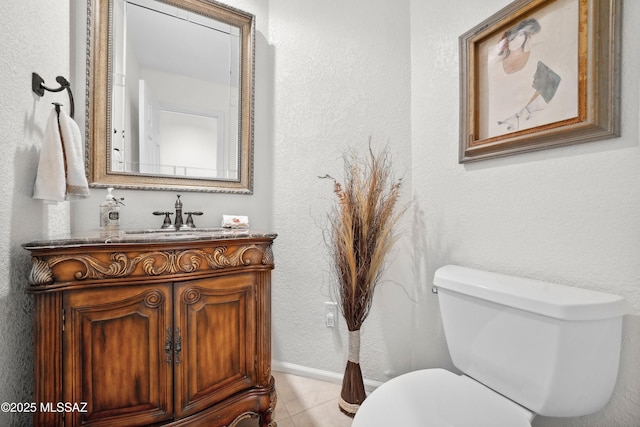 7133 E Grey Fox Ln, Tucson, AZ 85750 - bathroom with toilet, vanity, tile patterned floors, and a textured wall