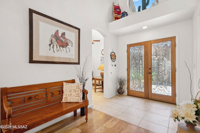 7133 E Grey Fox Ln, Tucson, AZ 85750 - foyer with french doors, arched walkways, and light wood finished floors