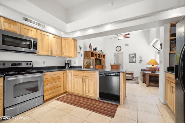 7133 E Grey Fox Ln, Tucson, AZ 85750 - kitchen featuring appliances with stainless steel finishes, a peninsula, light tile patterned floors, and dark countertops