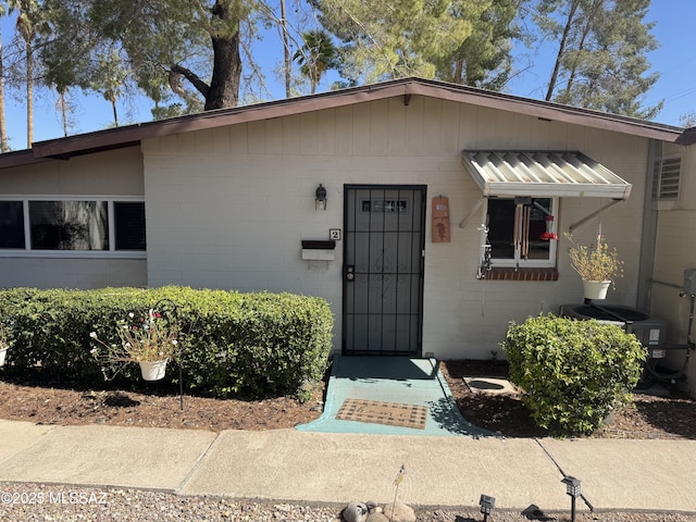 1002 S Kolb Rd Unit 2, Tucson, AZ 85710 - view of front of property featuring concrete block siding and cooling unit