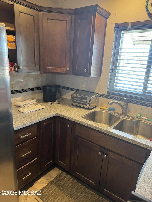 1002 S Kolb Rd Unit 2, Tucson, AZ 85710 - kitchen featuring stainless steel refrigerator, a sink, light countertops, and dark brown cabinets