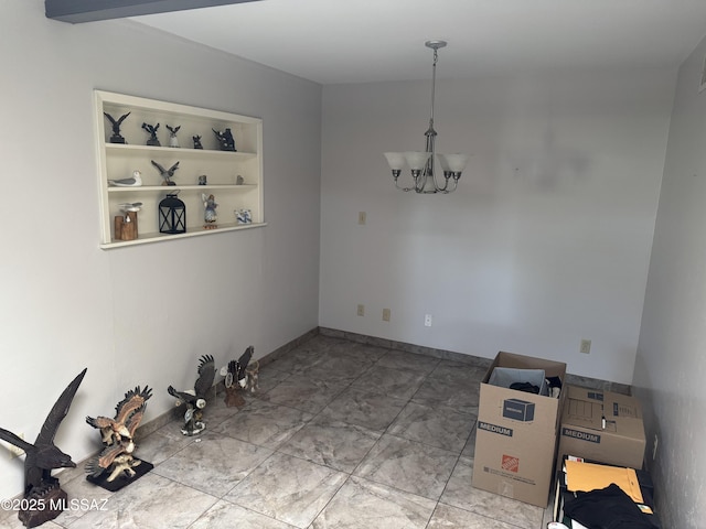 1002 S Kolb Rd Unit 2, Tucson, AZ 85710 - unfurnished dining area featuring a chandelier, baseboards, and marble finish floors