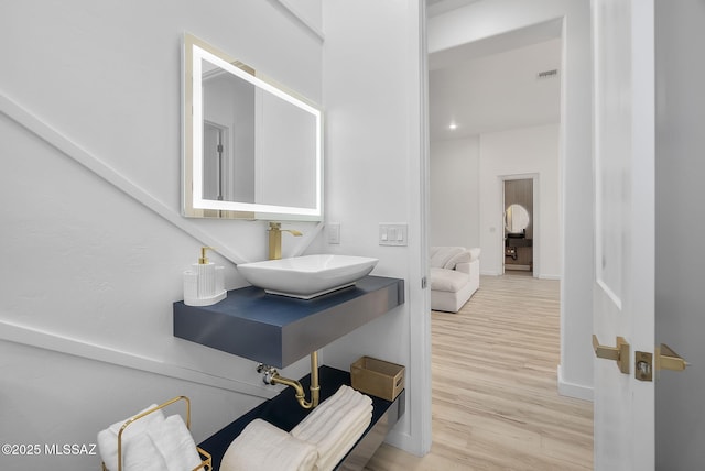 1803 Japon Ct, Rio Rico, AZ 85648 - bathroom with a sink, wood finished floors, ensuite bath, and baseboards