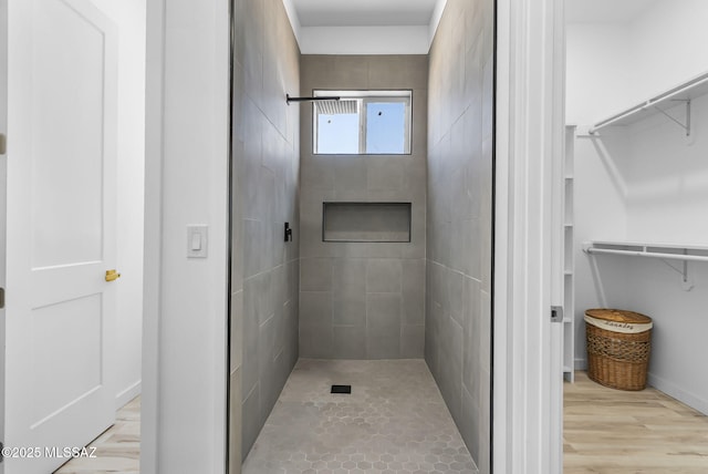 1803 Japon Ct, Rio Rico, AZ 85648 - bathroom with a tile shower, a walk in closet, and wood finished floors