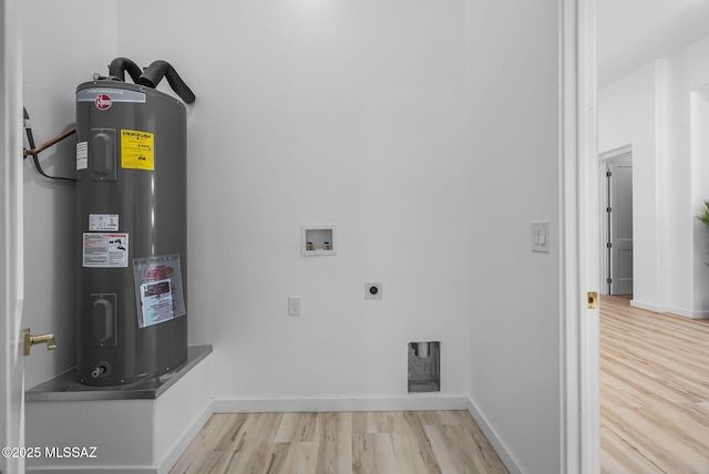 1803 Japon Ct, Rio Rico, AZ 85648 - clothes washing area featuring water heater, hookup for an electric dryer, washer hookup, wood finished floors, and baseboards