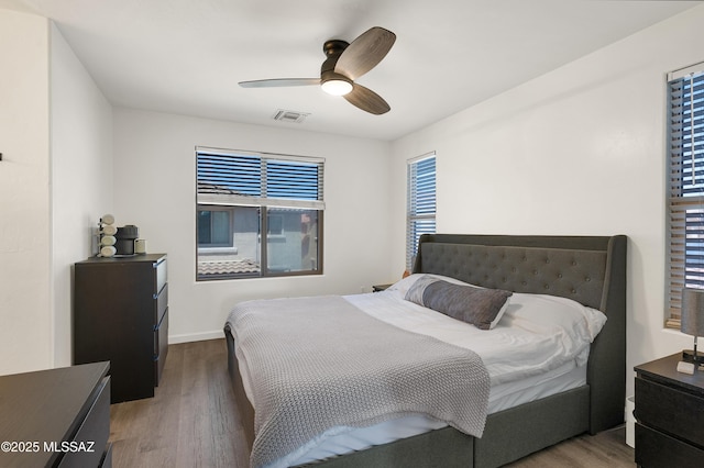 10583 E Forest Falls Ct, Tucson, AZ 85747 - bedroom featuring wood finished floors, ceiling fan, and baseboards