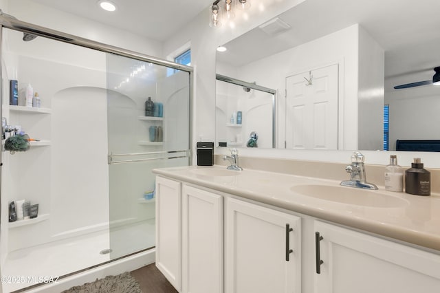 10583 E Forest Falls Ct, Tucson, AZ 85747 - bathroom featuring a stall shower, double vanity, and recessed lighting