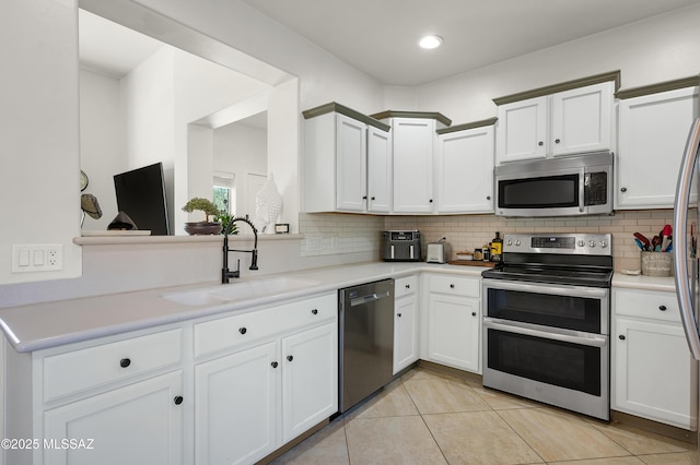10583 E Forest Falls Ct, Tucson, AZ 85747 - kitchen featuring appliances with stainless steel finishes, a sink, tasteful backsplash, light countertops, and recessed lighting