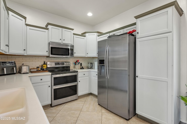 10583 E Forest Falls Ct, Tucson, AZ 85747 - kitchen with stainless steel appliances, decorative backsplash, light countertops, a sink, and recessed lighting