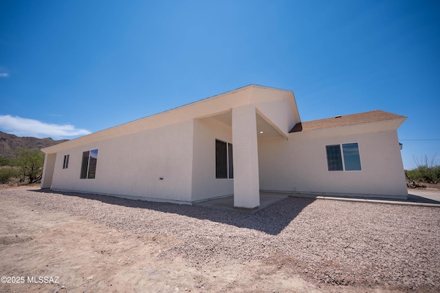 1681 Trampa Ct, Rio Rico, AZ 85648 - back of property with a mountain view, stucco siding, and a patio