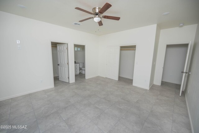 1681 Trampa Ct, Rio Rico, AZ 85648 - unfurnished bedroom featuring a closet, baseboards, ceiling fan, and ensuite bath