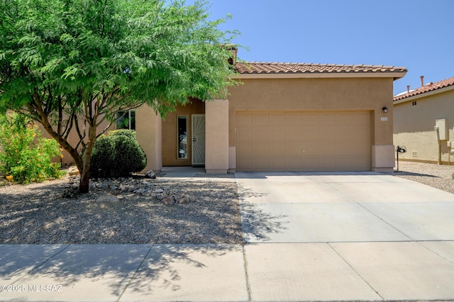2511 N Avenida Tabica, Green Valley, AZ 85614 - view of front facade featuring a garage, stucco siding, driveway, and a tile roof