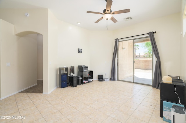 2511 N Avenida Tabica, Green Valley, AZ 85614 - living room with a ceiling fan, arched walkways, light tile patterned floors, and baseboards