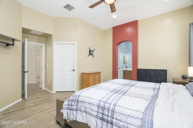 2511 N Avenida Tabica, Green Valley, AZ 85614 - bedroom with arched walkways, light wood-type flooring, baseboards, a ceiling fan, and recessed lighting