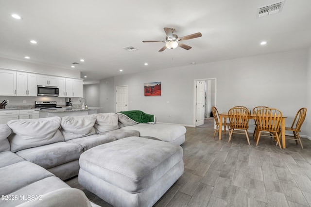 1941 E Greenlee Rd, Tucson, AZ 85719 - living room featuring recessed lighting, light wood finished floors, baseboards, and a ceiling fan