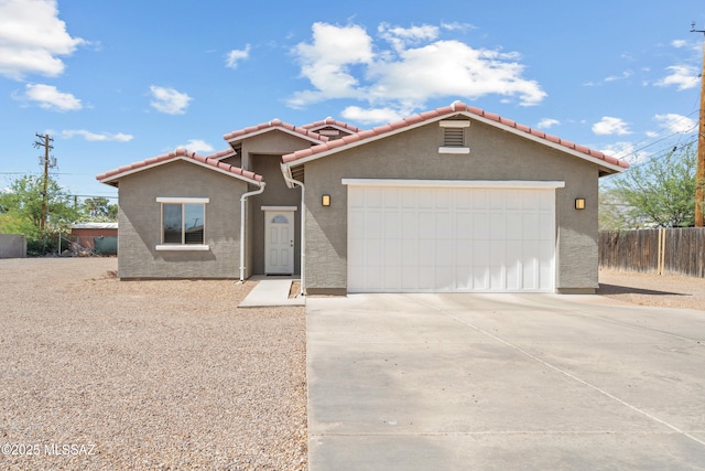 1941 E Greenlee Rd, Tucson, AZ 85719 - mediterranean / spanish home featuring driveway, a garage, a tile roof, and stucco siding