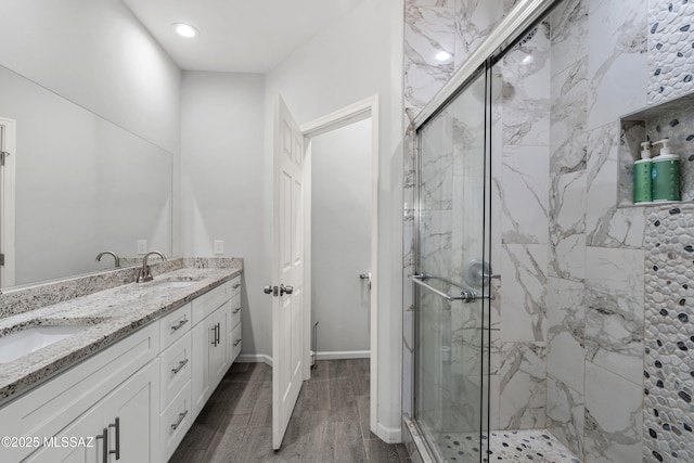 1941 E Greenlee Rd, Tucson, AZ 85719 - full bathroom featuring a marble finish shower, double vanity, wood finished floors, and recessed lighting