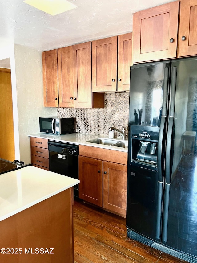 1632 N Columbus Blvd, Tucson, AZ 85712 - kitchen with black appliances, a sink, dark wood-style floors, light countertops, and a textured wall