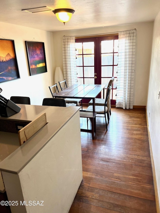 1632 N Columbus Blvd, Tucson, AZ 85712 - dining area featuring french doors, dark wood finished floors, and baseboards