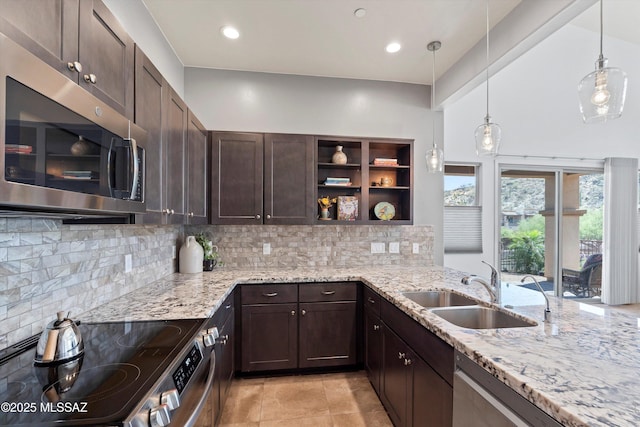 1759 E Via Colomba Bianca, Tucson, AZ 85737 - kitchen featuring stainless steel appliances, dark brown cabinetry, open shelves, a sink, and light stone countertops