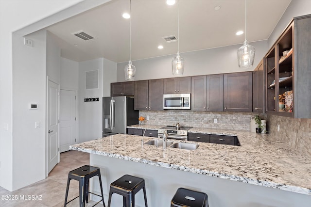 1759 E Via Colomba Bianca, Tucson, AZ 85737 - kitchen with appliances with stainless steel finishes, a sink, a peninsula, decorative backsplash, and recessed lighting