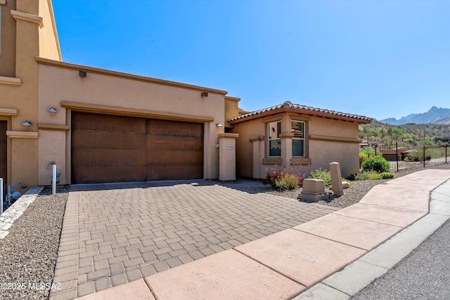 1759 E Via Colomba Bianca, Tucson, AZ 85737 - view of front facade featuring a mountain view, a garage, stucco siding, and decorative driveway
