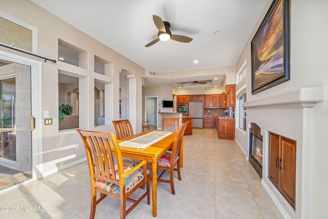 1861 E Crown Ridge Way, Oro Valley, AZ 85755 - dining room featuring a ceiling fan, light tile patterned floors, a glass covered fireplace, and recessed lighting