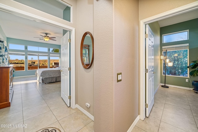 1861 E Crown Ridge Way, Oro Valley, AZ 85755 - corridor featuring light tile patterned flooring, baseboards, and a textured wall