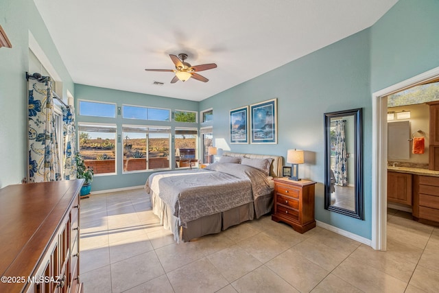 1861 E Crown Ridge Way, Oro Valley, AZ 85755 - bedroom featuring baseboards, light tile patterned floors, a ceiling fan, and connected bathroom