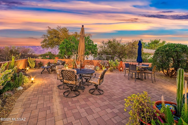 1861 E Crown Ridge Way, Oro Valley, AZ 85755 - patio terrace at dusk featuring outdoor dining area and a patio