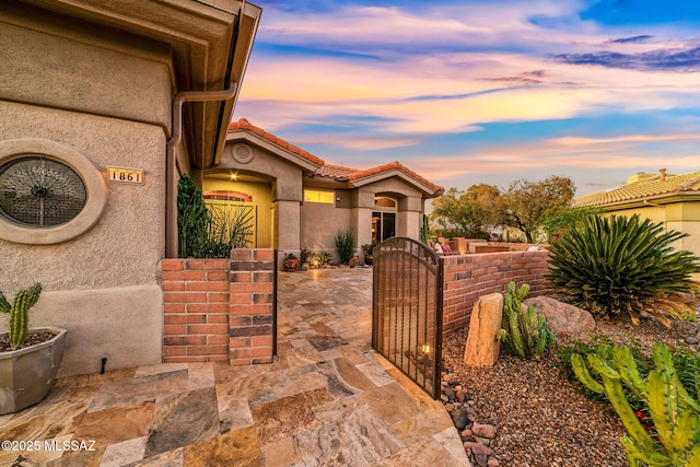 1861 E Crown Ridge Way, Oro Valley, AZ 85755 - view of front of home featuring a gate, stucco siding, and a fenced front yard
